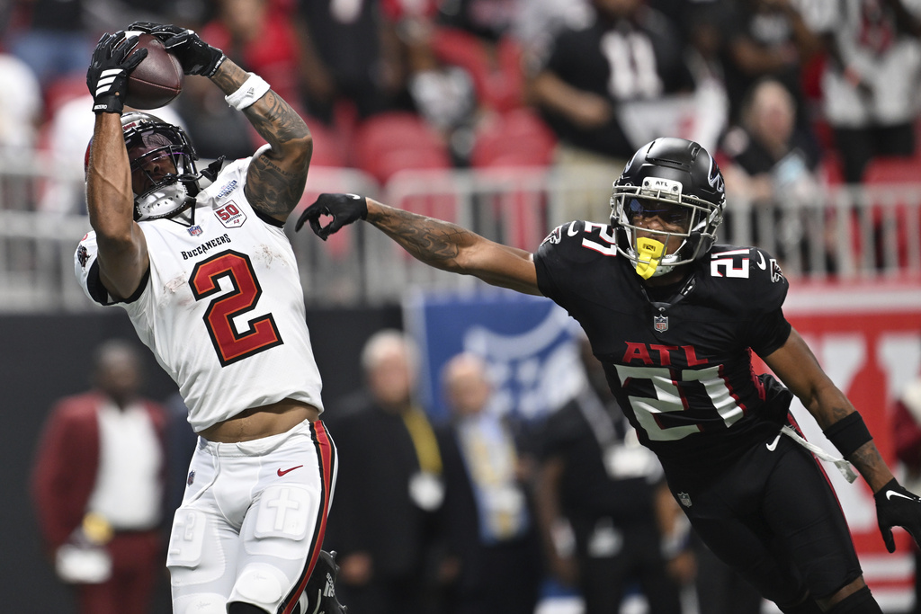 Tampa Bay Buccaneers wide receiver Emeka Egbuka (2) scores a touchdown against Tampa Bay Buccaneers cornerback Benjamin Morrison (21) during the second half of an NFL football game, Sunday, Sept. 7, 2025, in Atlanta. (AP Photo/Danny Karnik)