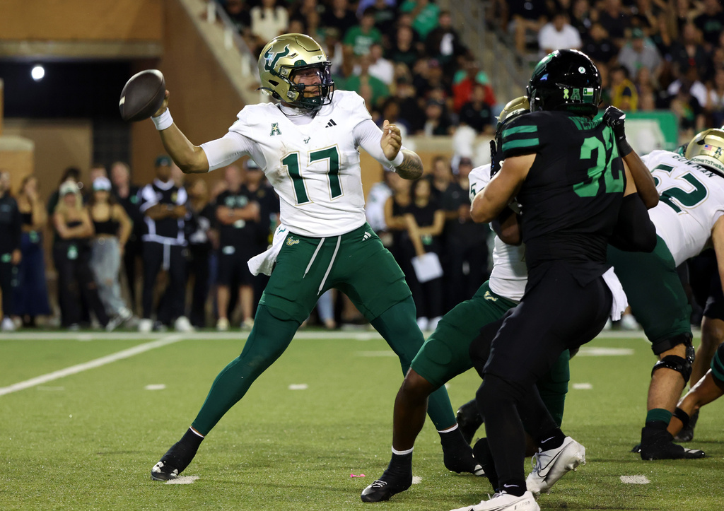 South Florida quarterback Byrum Brown (17) looks to throw a pass against North Texas in the second quarter of an NCAA college football game Friday, Oct. 10, 2025, in Denton, Texas. (AP Photo/Richard W. Rodriguez)