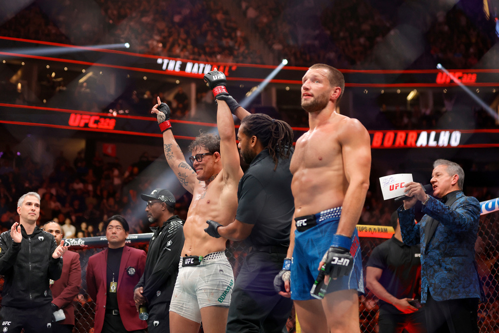 Caio Borralho, left, is declared the winner over Reinier de Ridder in a middleweight bout during UFC 326 Saturday, March 7, 2026, in Las Vegas. (Steve Marcus/Las Vegas Sun via AP)
