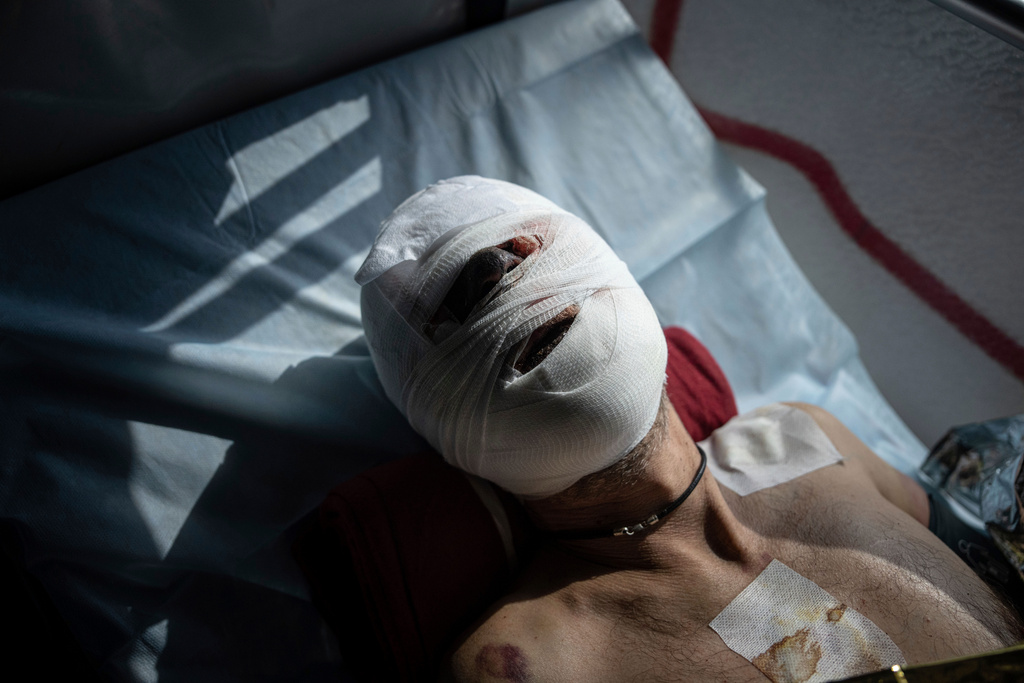FILE - A wounded Ukrainian soldier lies in a medical evacuation bus run by volunteers from the Hospitallers paramedic organization in Donetsk, Ukraine, on Wednesday, March 22, 2023. (AP Photo/Evgeniy Maloletka, File)