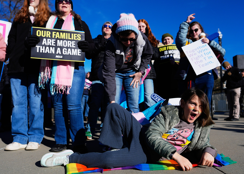 Emily, 9, and other protesters, gather outside the Supreme Court as it hears arguments over state laws barring transgender girls and women from playing on school athletic teams, Tuesday, Jan. 13, 2026, in Washington. (AP Photo/Julia Demaree Nikhinson)