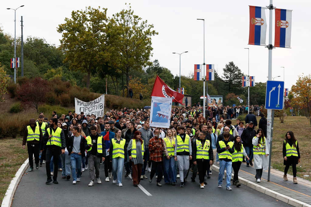 People march during a protest in Belgrade, Serbia, Wednesday, Oct. 1, 2025, eleven months after the deadly train station tragedy that sparked mass demonstrations against corruption. (AP Photo/Marko Drobnjakovic)