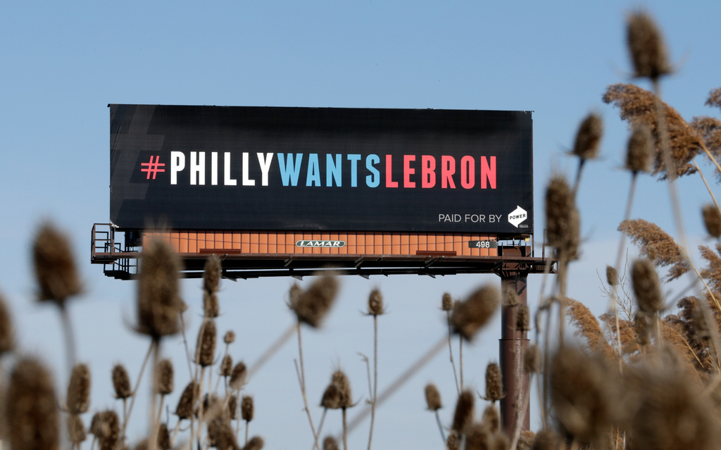 FILE - One of three billboards trying to entice Cleveland Cavaliers' LeBron James to come to Philadelphia are shown near a highway, Tuesday, Feb. 27, 2018, in Cleveland. (AP Photo/Tony Dejak, File)