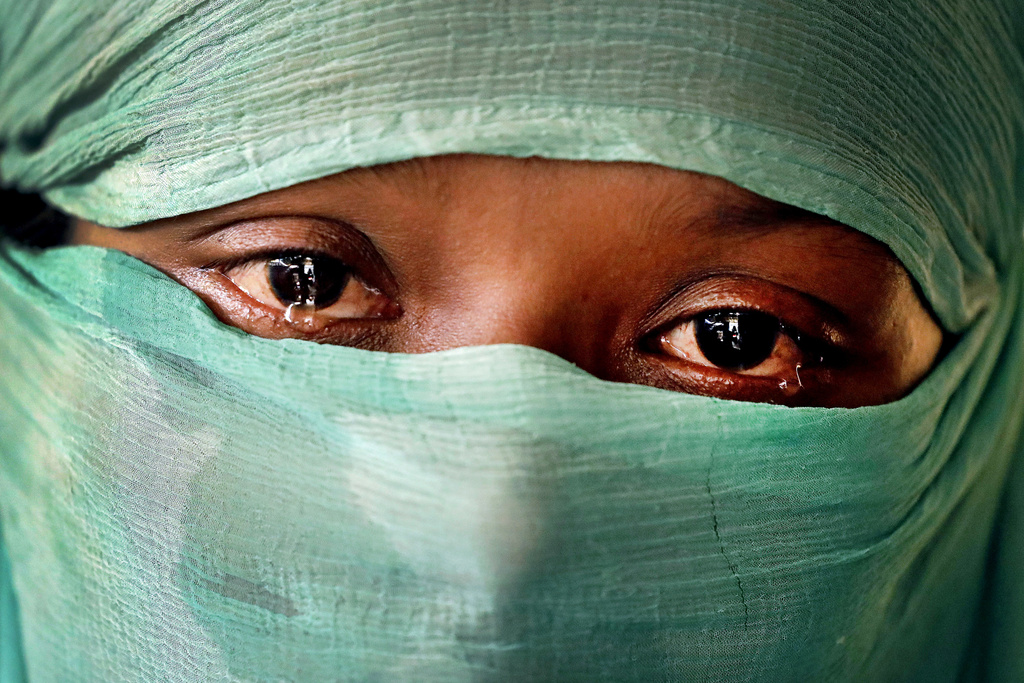 -FILE- In this Wednesday, Nov. 22, 2017, photo, F, 22, who says she was raped by members of Myanmar's armed forces in June and again in September, is photographed in her tent in Kutupalong refugee camp in Bangladesh. (AP Photo/Wong Maye-E, file)