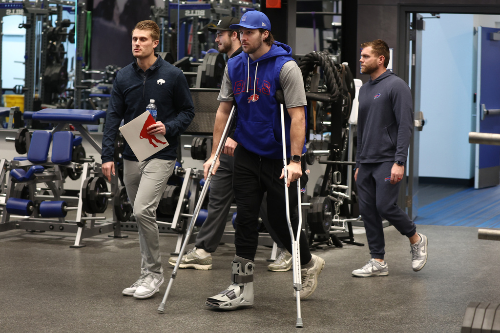 Buffalo Bills quarterback Josh Allen, center, arrives at a press conference to announce Joe Brady as the new head coach in Orchard Park, N.Y., Thursday, Jan. 29, 2026. (AP Photo/Jeffrey T. Barnes)