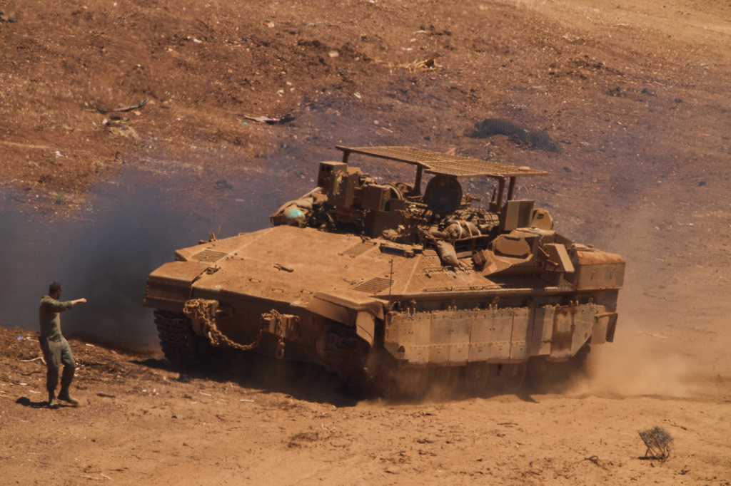 An Israeli soldier directs an APC near the border with Lebanon in northern Israel, Wednesday, July 1, 2026. (AP Photo/Ariel Schalit)