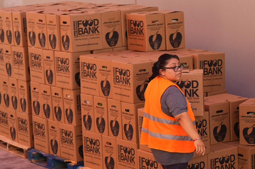 Volunteer Cindy Leiva helps load a vehicle during a food distribution targeting federal employee households affected by the federal shutdown as well as SNAP recipients, Monday, Oct. 27, 2025, in San Antonio. (AP Photo/Eric Gay) Volunteer Cindy Leiva helps load a vehicle during a food distribution targeting federal employee households affected by the federal shutdown as well as SNAP recipients, Monday, Oct. 27, 2025, in San Antonio. (AP Photo/Eric Gay)