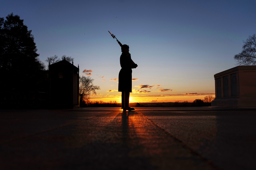 A U.S. Army honor guard member stands vigil at dawn at the Tomb of the Unknown Soldier on Tuesday, March 17, 2026, at Arlington National Cemetery in Arlington, Va., ahead of the 100th anniversary of a continuous honor guard presence at the tomb, celebrated March 25, 2026. (AP Photo/Mark Schiefelbein)