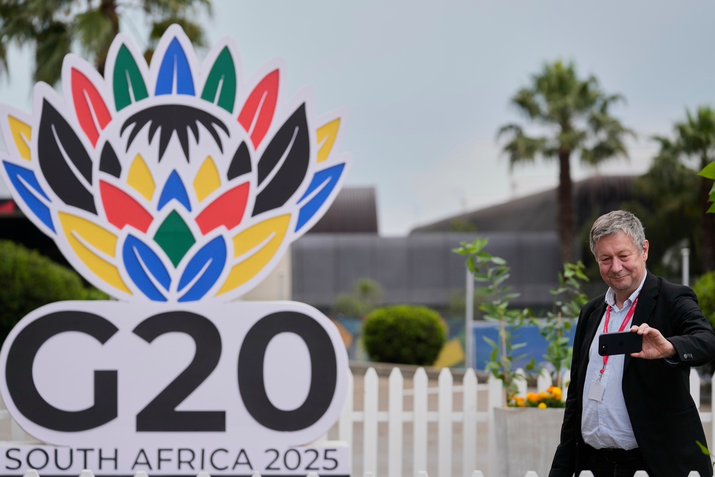 A journalist takes a selfie outside the media centre of the G20 Summit in Johannesburg, South Africa, Friday, Nov. 21, 2025. (AP Photo/Themba Hadebe)