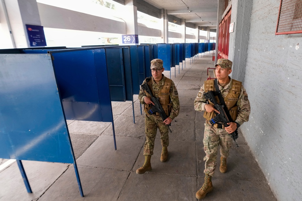 Soldiers patrol the National Stadium, which will be used as a polling station during Sunday's general elections, in Santiago, Chile, Saturday, Nov. 15, 2025. (AP Photo/Esteban Felix)