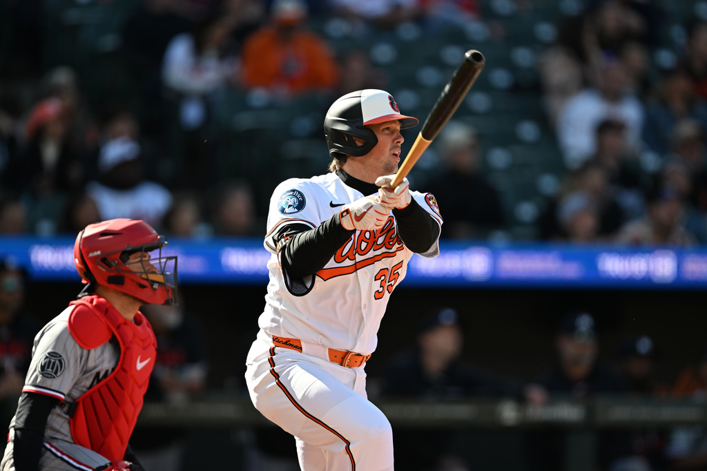 Baltimore Orioles' Adley Rutschman follows through on a one-run double against the Minnesota Twins to score the go-ahead run during the seventh inning of an MLB baseball game, Sunday, March 29, 2026 in Baltimore. (AP Photo/Gail Burton)