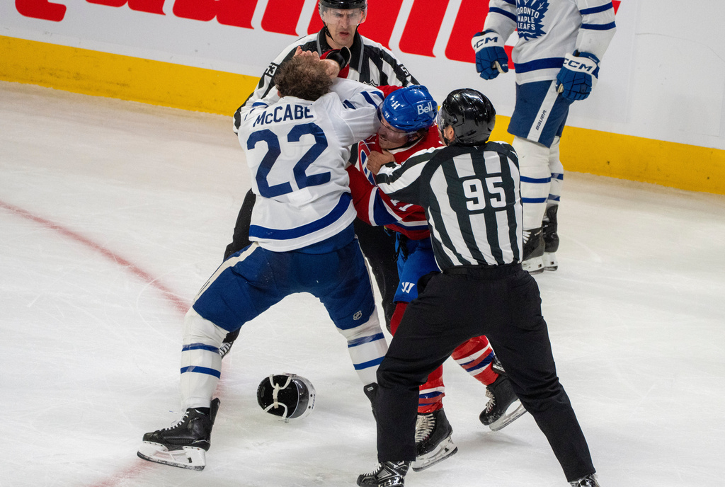 Montreal Canadiens' Brendan Gallagher and Toronto Maple Leafs' Jake McCabe (22) fight during the first period of an NHL hockey game in Montreal, Tuesday, March 10, 2026. (Christinne Muschi/The Canadian Press via AP)