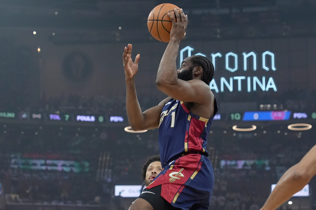 Cleveland Cavaliers' James Harden, right, shoots in front of Detroit Pistons' Cade Cunningham, rear, in the first half of Game 4 of a second-round NBA basketball playoff series Monday, May 11, 2026, in Cleveland. (AP Photo/Sue Ogrocki)