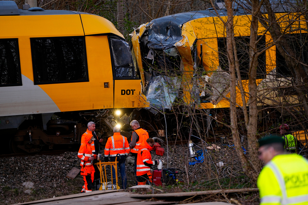 Emergency personnel work at the site where two trains collided near Hilleroed, Denmark, on Thursday, April 23, 2026. (Mads Claus Rasmussen/Ritzau Scanpix via AP)