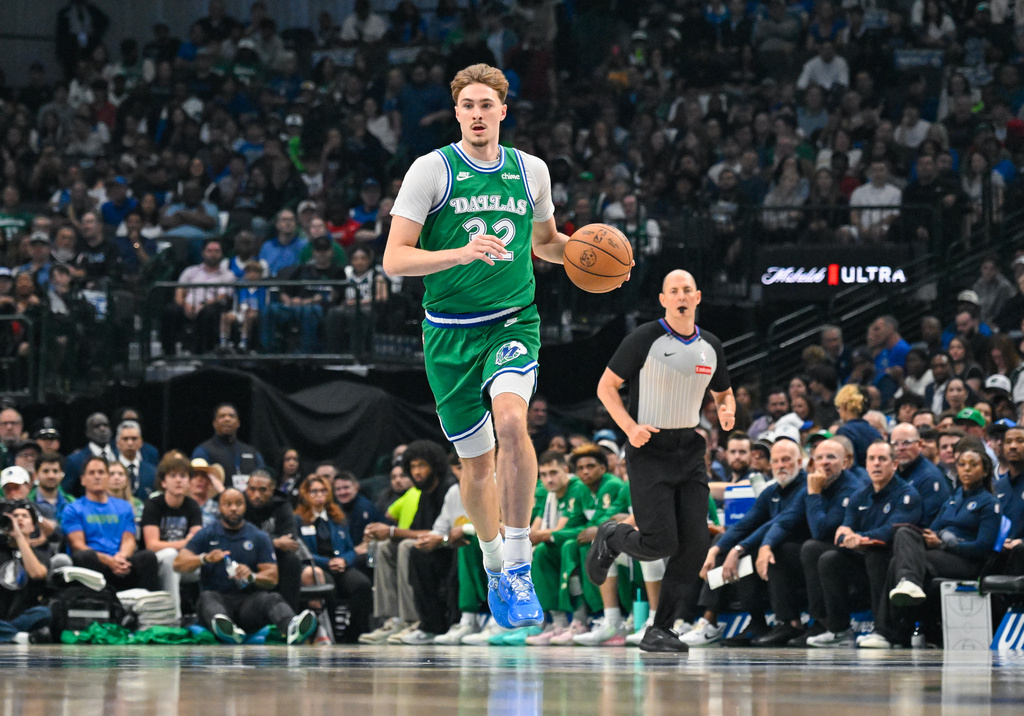 Dallas Mavericks' Cooper Flagg brings the ball up court during an NBA basketball game against the Chicago Bulls Sunday, April 12, 2026, in Dallas. (AP Photo/Albert Pena)