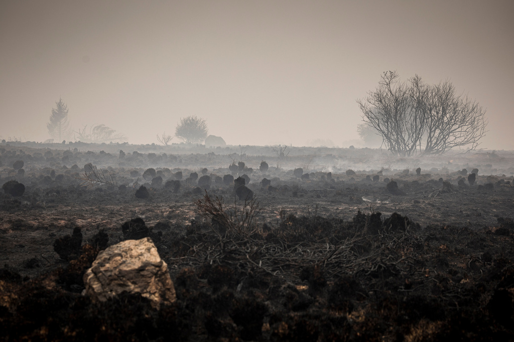 Smoke rises from burned-out parts of the Hautes Fagnes near Waimes, Belgium, Sunday, Aug. 16, 2026. (Photo AP/Valentin Bianchi)