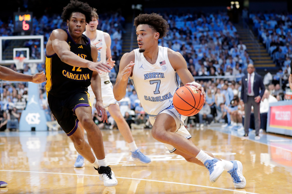North Carolina guard Seth Trimble (7) drives against East Carolina guard Jordan Riley, left, during the first half of an NCAA college basketball game Monday, Dec. 22, 2025, in Chapel Hill, N.C. (AP Photo/Chris Seward)