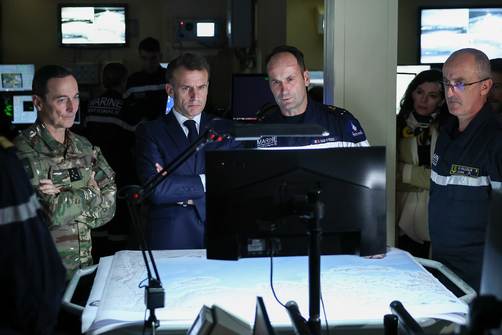 French President Emmanuel Macron, center left, visits the bridge of the French aircraft carrier Charles de Gaulle, during his visit to Cyprus, Monday March 9, 2026. (Gonzalo Fuentes/Pool Photo via AP)