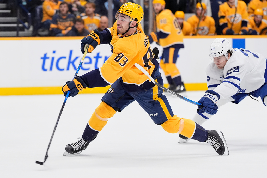 Nashville Predators defenseman Adam Wilsby (83) scores a goal past Toronto Maple Leafs left wing Matthew Knies (23) during the second period of an NHL hockey game Saturday, Dec. 20, 2025, in Nashville, Tenn. (AP Photo/George Walker IV)