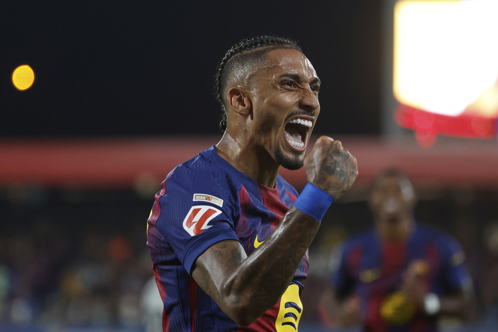 Barcelona's Raphinha celebrates scoring his side's 4th goal during a Spanish La Liga soccer match between FC Barcelona and Valencia at the Johan Cruyff stadium in Barcelona, Spain, Sunday, Sept. 14, 2025. (AP Photo/Joan Monfort)