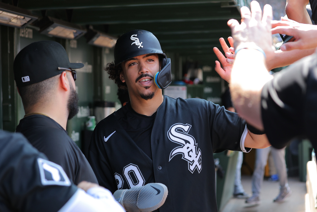 Chicago White Sox's Miguel Vargas celebrates in the dugout after scoring on Braden Montgomery's two-run double during the eighth inning of a baseball game against the Chicago Cubs, Wednesday, Aug. 19, 2026, in Chicago. (AP Photo/Melissa Tamez)