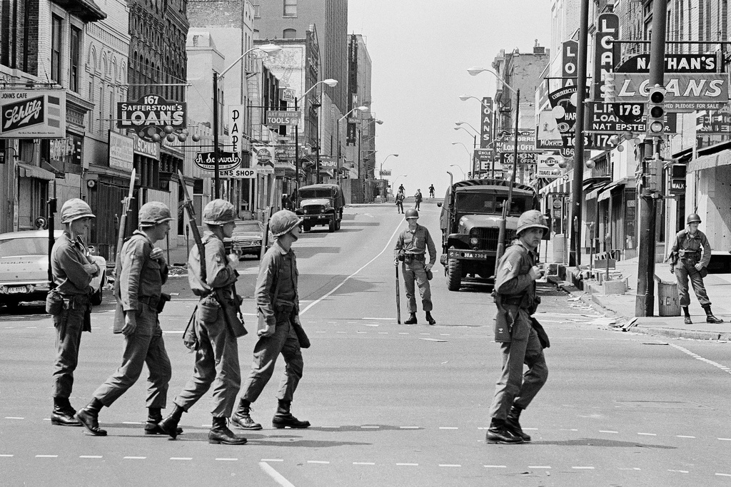 FILE - A relief squad of the Tennessee National Guard files across Beale Street in Memphis, Tenn., to replace troopers already stationed at strategic points in the racially tense city, March 30, 1968. The troops have been on duty in Memphis since violence erupted during a march led by Dr, Martin Luther King Jr. on March 28. (AP Photo/Charles Kelly, File)