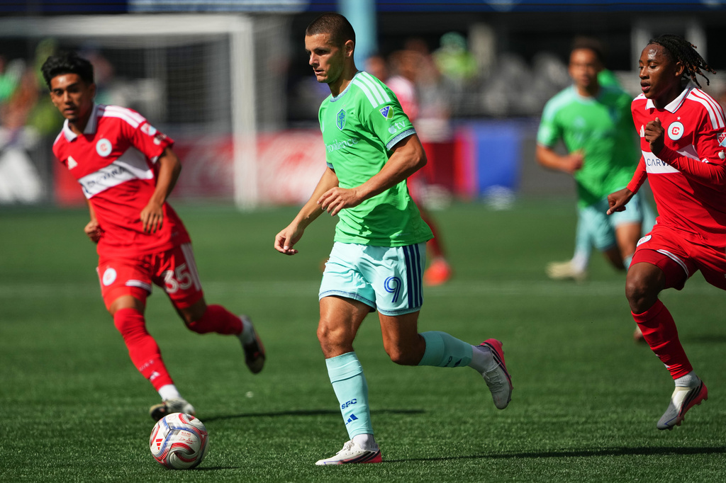 Seattle Sounders forward Dejan Joveljic moves the ball against the Chicago Fire FC, including midfielder Sergio Oregel (35) during the second half of an MLS soccer match, Saturday, Aug. 29, 2026, in Seattle. (AP Photo/Lindsey Wasson)