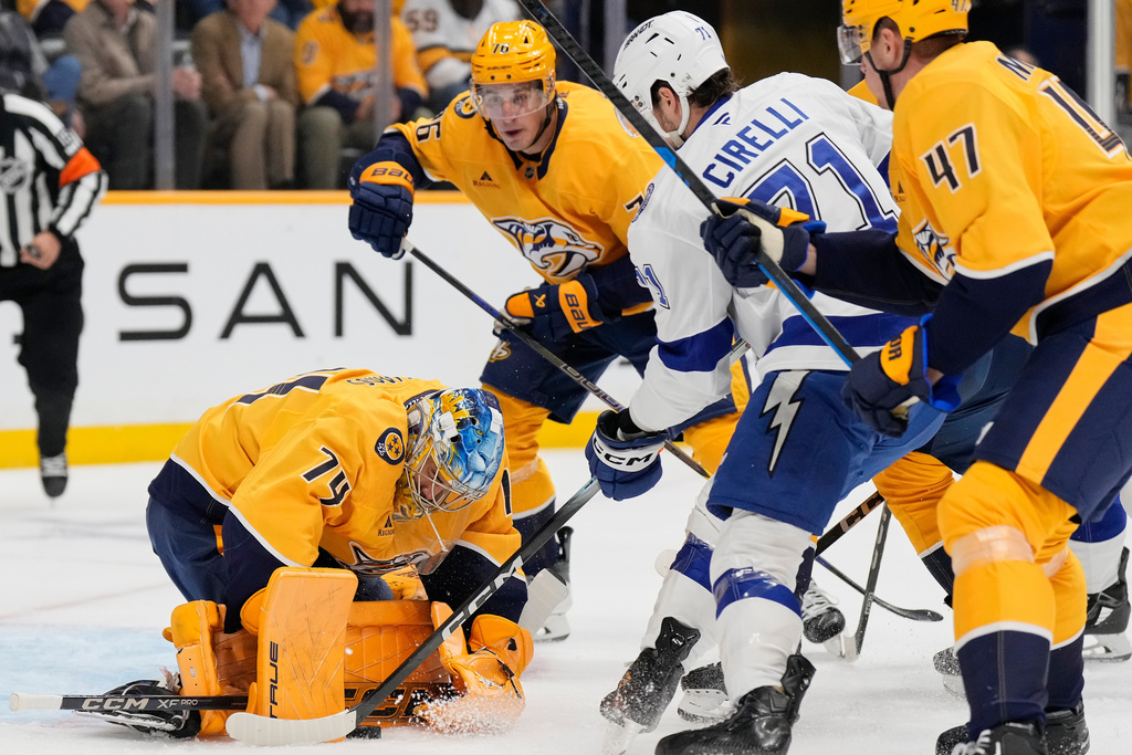 Nashville Predators goaltender Juuse Saros (74) defends the goal against the Tampa Bay Lightning center Anthony Cirelli (71) during the first period of an NHL hockey game Tuesday, Oct. 28, 2025, in Nashville, Tenn. (AP Photo/George Walker IV)