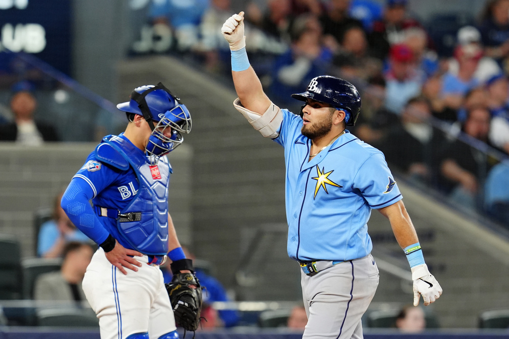 Toronto Blue Jays catcher Brandon Valenzuela, left, looks on as Tampa Bay Rays' Jonathan Aranda, right, celebrates after hitting a solo home run during fifth-inning baseball game action in Toronto, Monday, May 11, 2026. (Frank Gunn/The Canadian Press via AP)