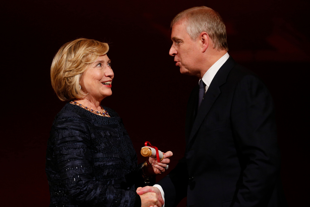 FILE - Britain's Prince Andrew, right, talks to former U.S. Secretary of State Hillary Clinton, left, as she is presented with the Chatham House prize, a scroll signed by Queen Elizabeth II, Patron of the institute, during the Chatham House Prize award ceremony in central London, Friday, Oct. 11, 2013. (AP Photo/Lefteris Pitarakis, File)