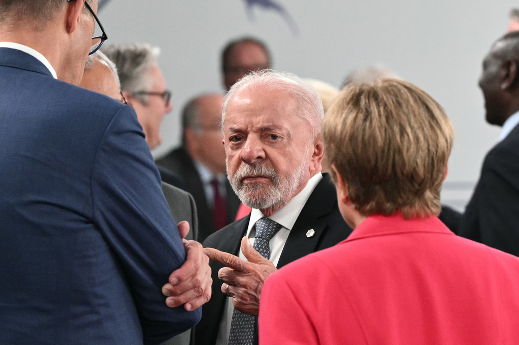 Brazil's President Luiz Inacio Lula da Silva, center, gestures as he speaks with Germany's Chancellor Friedrich Merz and IMF Managing Director Kristalina Georgieva, ahead of a working session at the G7 summit, in Evian-les-Bains, France, Wednesday, June 17, 2026. (Mandel Ngan/Pool Photo via AP)