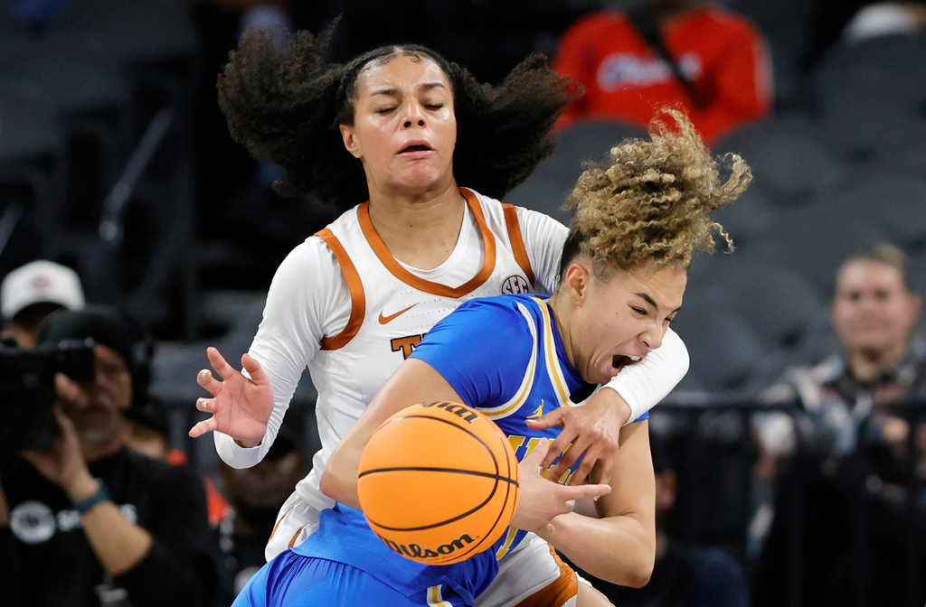 Texas guard Jordan Lee, left, knocks the ball away from UCLA guard Kiki Rice during the first half of an NCAA college basketball game in the Players Era tournament Wednesday, Nov. 26, 2025, in Las Vegas. (AP Photo/Steve Marcus)