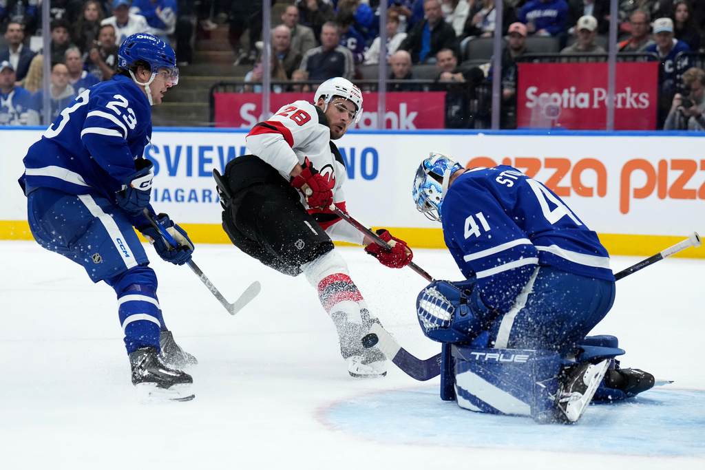 Toronto Maple Leafs goaltender Anthony Stolarz (41) makes a save on New Jersey Devils right wing Timo Meier (28) during the third period of an NHL hockey game in Toronto, Tuesday, Oct. 21, 2025. (Nathan Denette/The Canadian Press via AP)