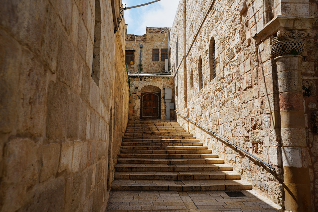 A locked door and empty stairs leading to the Church of the Holy Sepulchre in Jerusalem's Old City, closed to visitors amid heightened security during the war with Iran, Friday, March 27, 2026. (AP Photo/Mahmoud Illean)