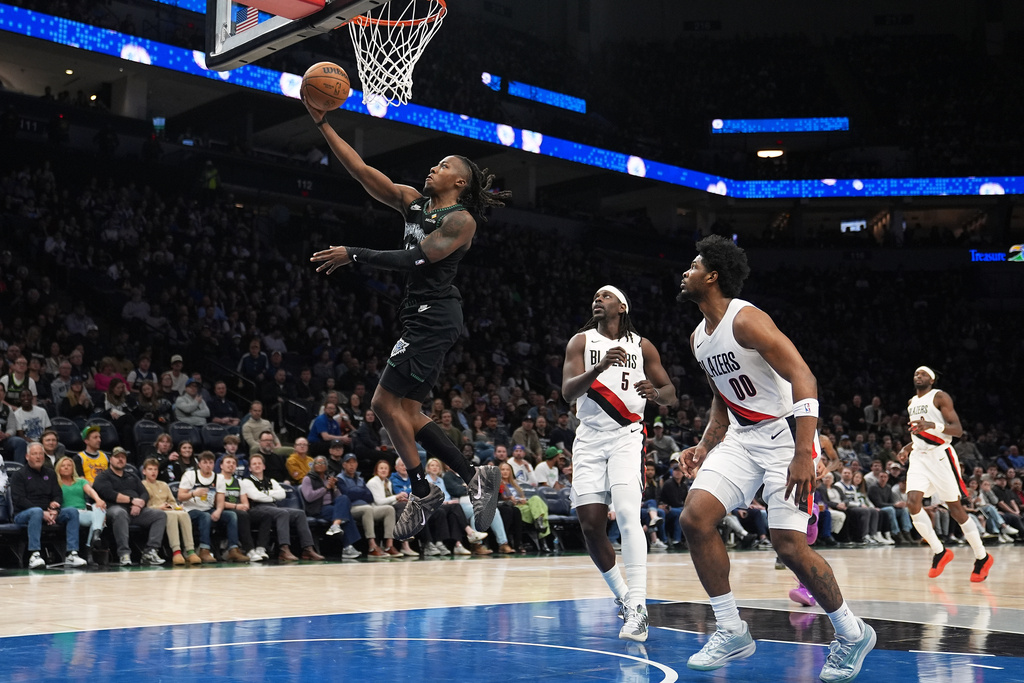 Minnesota Timberwolves guard Ayo Dosunmu (13) goes up to shoot during the first half of an NBA basketball game against the Portland Trail Blazers, Friday, March 20, 2026, in Minneapolis. (AP Photo/Abbie Parr)