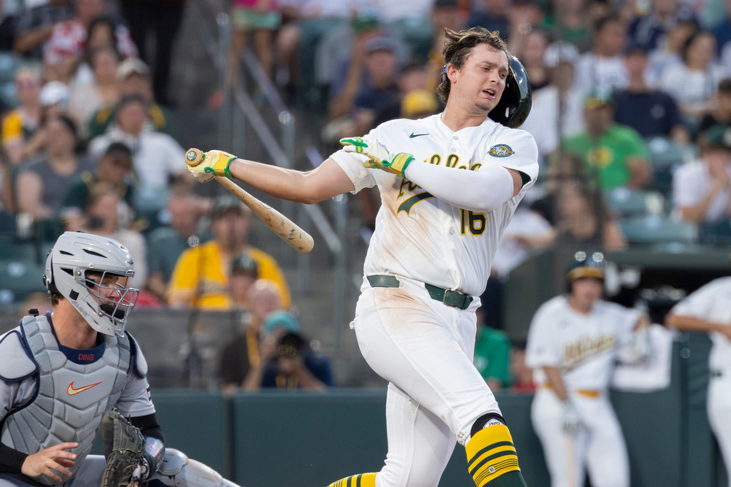 Athletics' Nick Kurtz loses his batting helmet on a swing during the fifth inning of a baseball game against the Detroit Tigers, Friday, July 31, 2026, in West Sacramento, Calif. (AP Photo/Sara Nevis)