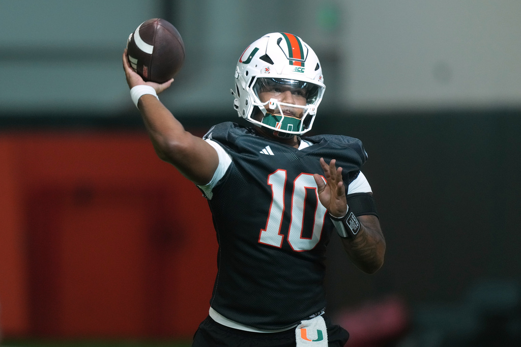 FILE - Miami quarterback Darian Mensah (10) throws a pass during NCAA college practice, Tuesday, Aug. 4, 2026, in Coral Gables, Fla. (AP Photo/Marta Lavandier, FIle)