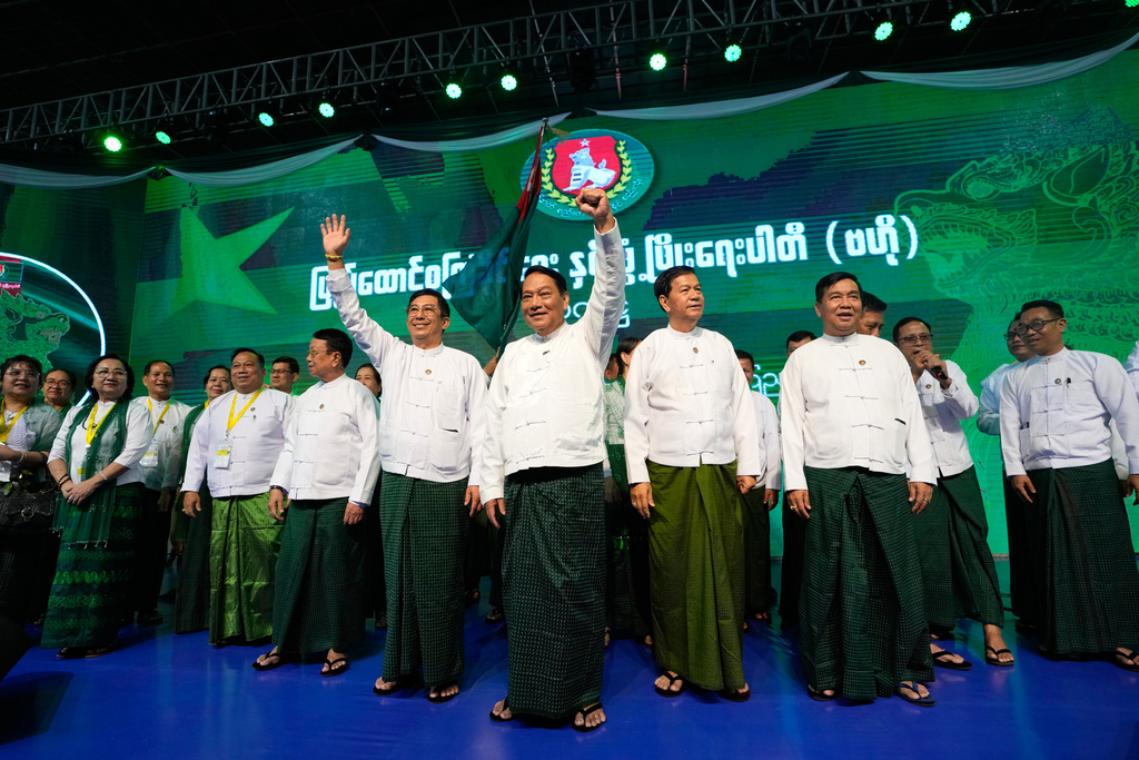 FILE - Khin Yi, center, chairman of the military-backed Union Solidarity and Development Party (USDP), cheers together with the party's members during a ceremony to release the party's election manifesto at Thuwunna indoor stadium Wednesday, Nov. 19, 2025, in Yangon, Myanmar. (AP Photo/Thein Zaw, File)