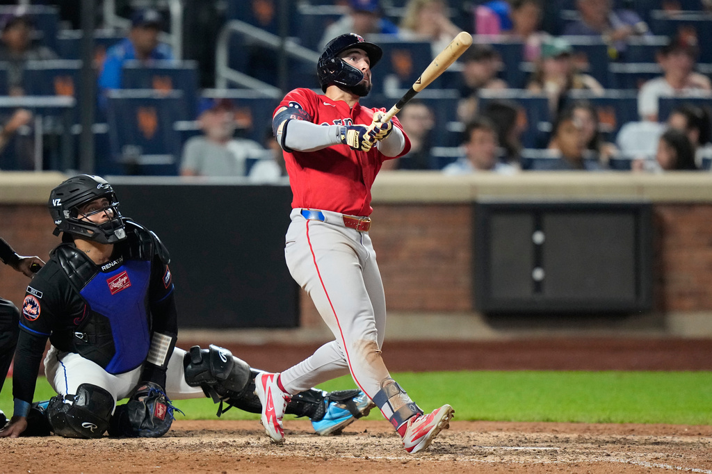 New York Mets catcher Francisco Alvarez, left, watches as Boston Red Sox's Wilyer Abreu follows through on a two-run home run during the ninth inning of a baseball game Friday, July 10, 2026, in New York. (AP Photo/Frank Franklin II)