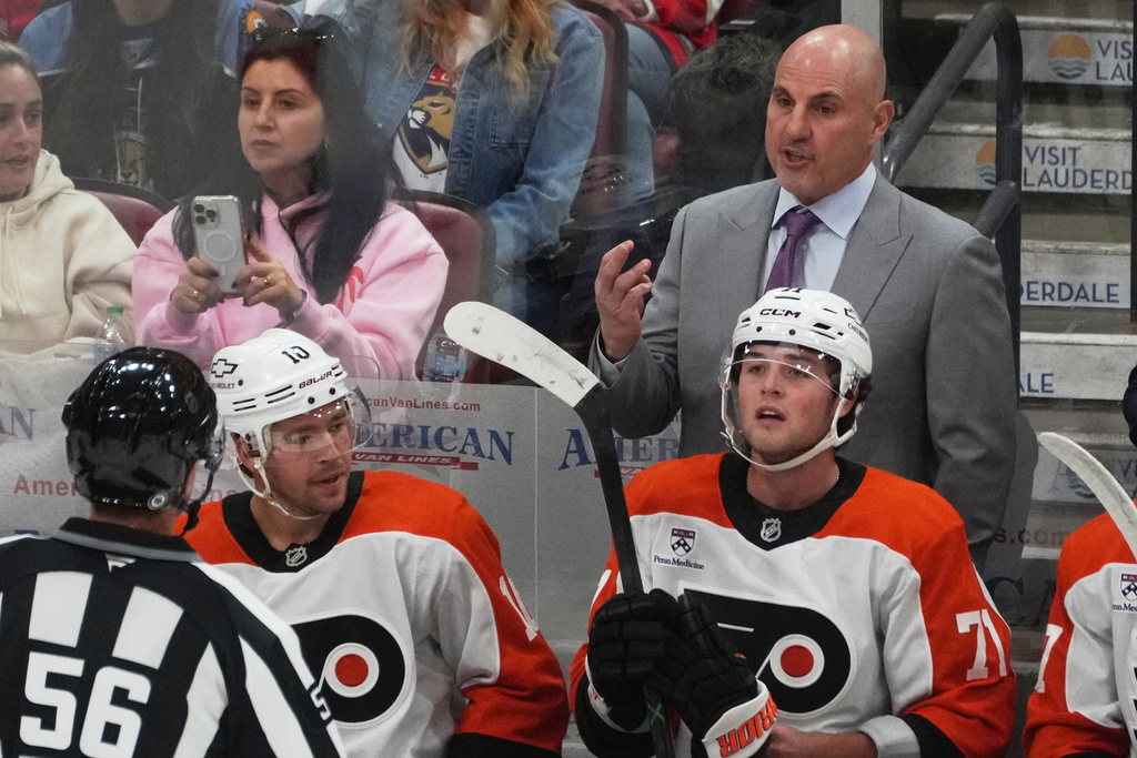 Philadelphia Flyers head coach Rick Tocchet gestures to referee Matt McPherson (56) during the first period of an NHL hockey game against the Florida Panthers, Thursday, Oct. 9, 2025, in Sunrise, Fla. (AP Photo/Marta Lavandier)