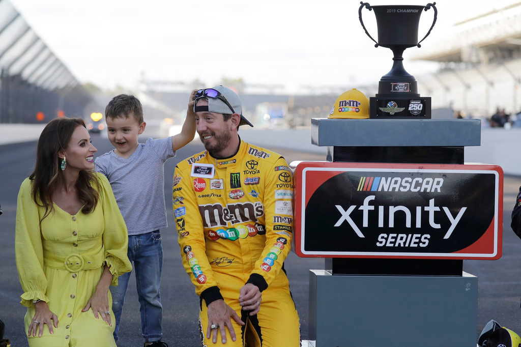 FILE - NASCAR Xfinity Series driver Kyle Busch celebrates with his wife, Samantha, and son, Brexton, after winning the NASCAR Xfinity auto race at the Indianapolis Motor Speedway, Sept. 7, 2019 in Indianapolis. (AP Photo/Darron Cummings, File)
