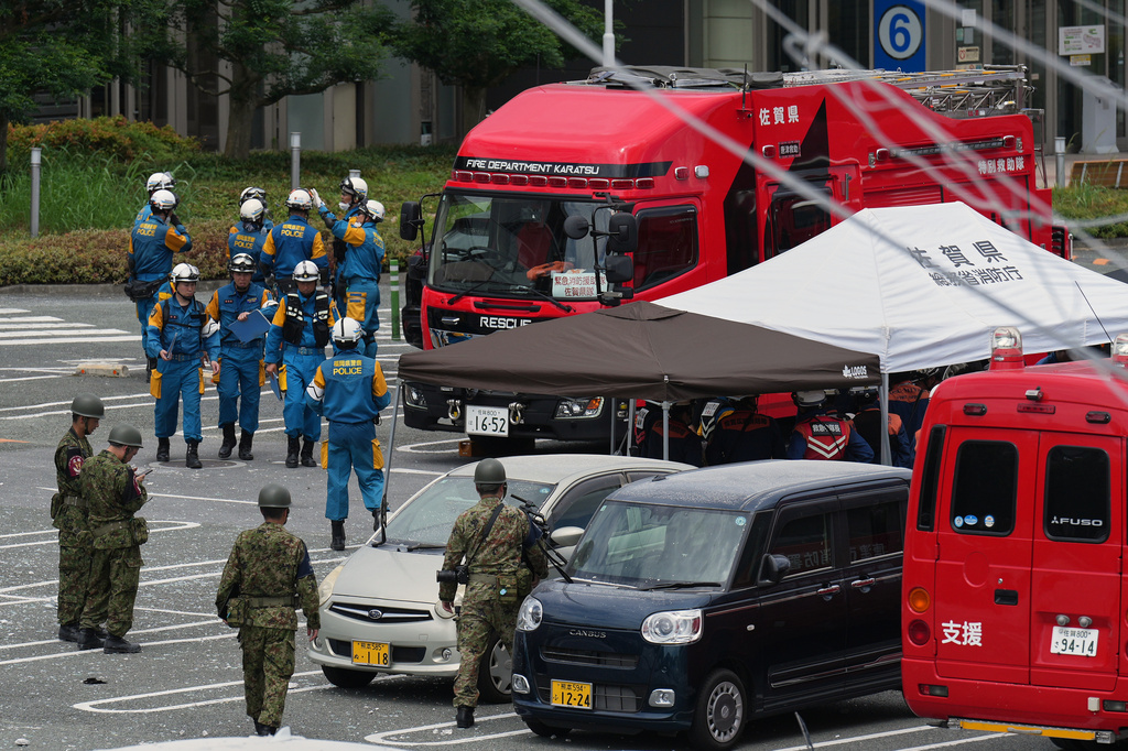Firefighters and Self Defense Force members prepare their work at AEON Mall, which was damaged by an explosion following an earthquake, is seen in Kashima, Kumamoto Prefecture, southern Japan, Wednesday, July 29, 2026. (AP Photo/Hiro Komae)
