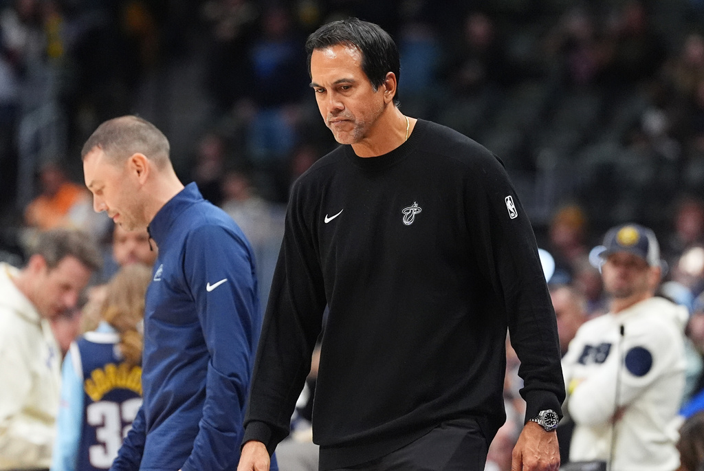 Miami Heat head coach Erik Spoelstra, front, heads to the lockerroom after greeting Denver Nuggets head coach David Adelman following an NBA basketball game Wednesday, Nov. 5, 2025, in Denver. (AP Photo/David Zalubowski)