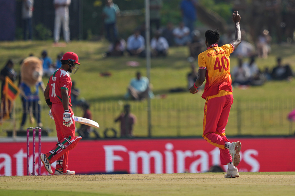 Zimbabwe's Blessing Muzarabani, right, celebrates the wicket of Oman's Karan Sonavale during the T20 World Cup cricket match between Oman and Zimbabwe in Colombo, Sri Lanka, Monday, Feb. 9, 2026. (AP Photo/Eranga Jayawardena)