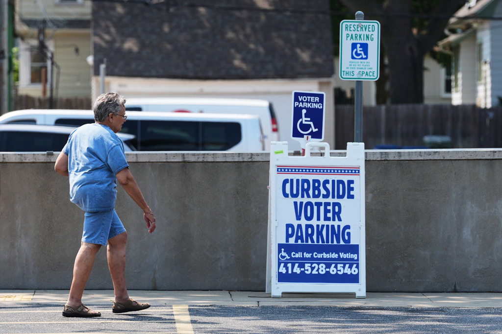 A voter arrives at a polling place in Milwaukee, Tuesday, July 28, 2026. (AP Photo/Nam Y. Huh)