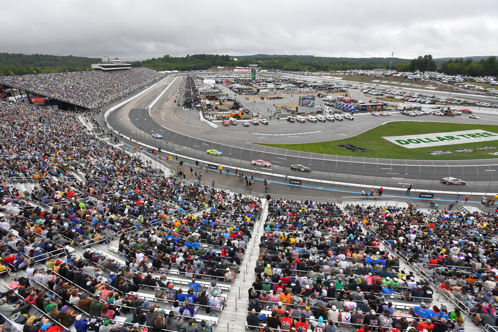 People watch as cars make their way through Turn 1 during a NASCAR Cup Series auto race, Sunday, Aug. 23, 2026, at New Hampshire Motor Speedway in Loudon, N.H. (AP Photo/Steven Senne)