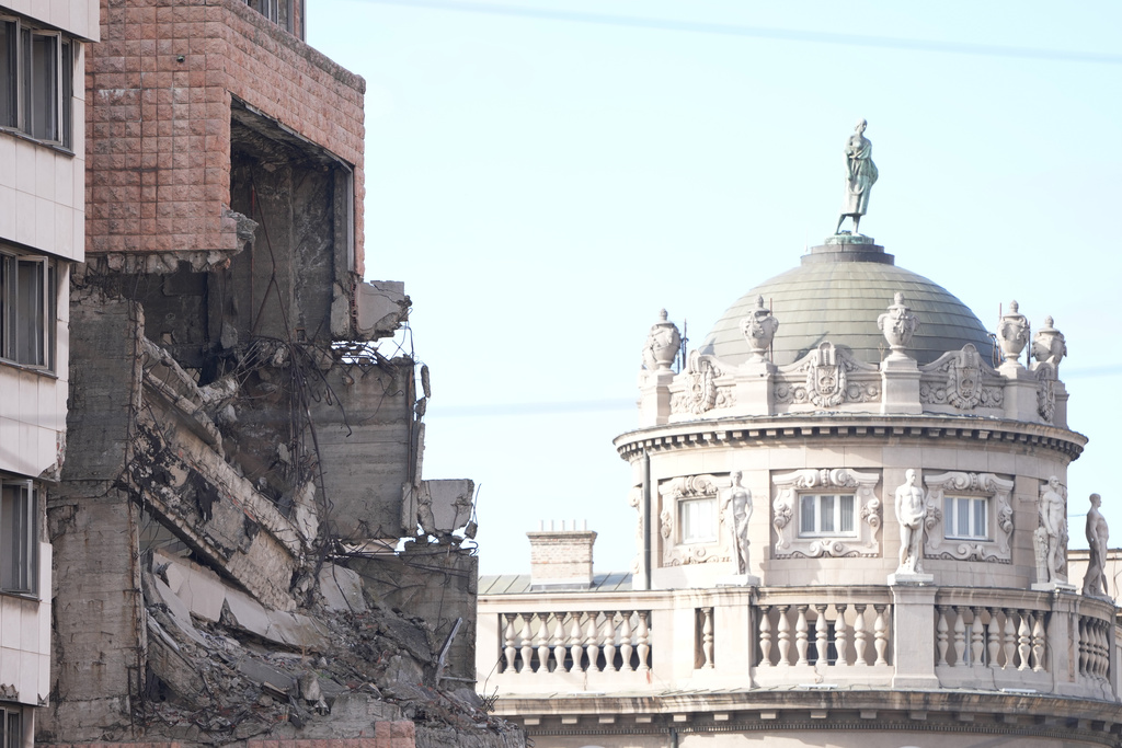 A former Yugoslav army headquarters destroyed in a U.S.-led NATO bombing campaign in 1999, left, is seen in Belgrade, Serbia, Tuesday, Nov. 4, 2025. (AP Photo/Darko Vojinovic)