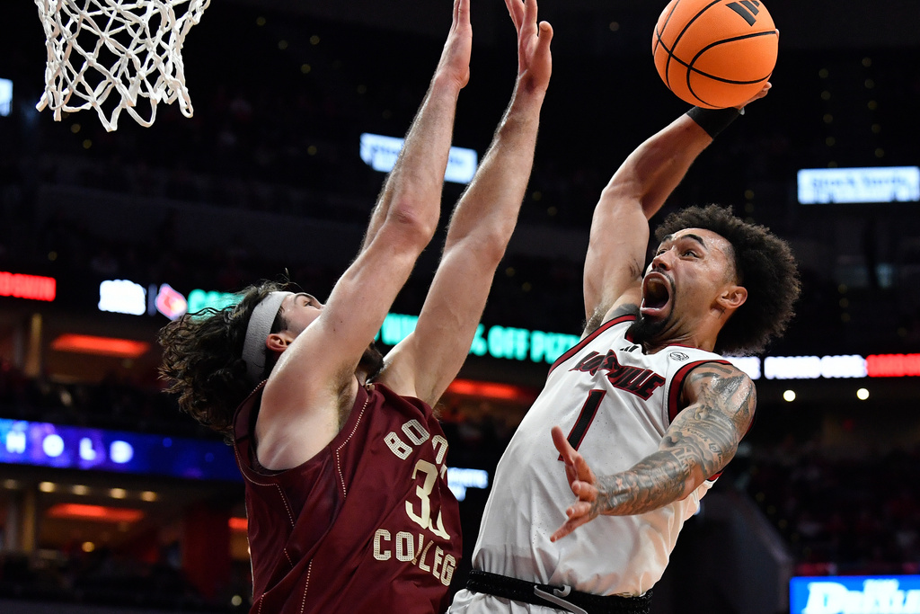 Louisville guard J'vonne Hadley (1) goes in for a dunk against Boston College center Boden Kapke (33) during the second half of an NCAA college basketball game in Louisville, Ky., Saturday, Jan. 10, 2026. (AP Photo/Timothy D. Easley)