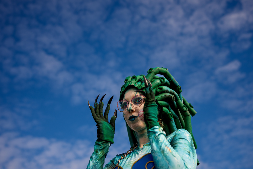 A girl adjusts her outfit at the West Side Hallo Fest, the country's largest Halloween festival in Bucharest, Romania, Saturday, Oct. 25, 2025. (AP Photo/Andreea Alexandru)