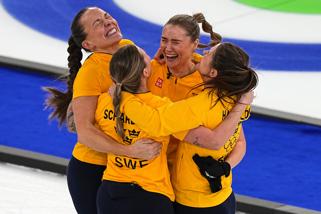 Sweden's Anna Hasselborg, Sara McManus, Sofia Scharback, Agnes Knochenhauer celebrate winning a women's curling semifinal match against Canada at the 2026 Winter Olympics, in Cortina d'Ampezzo, Italy, Friday, Feb. 20, 2026. (AP Photo/Fatima Shbair)
